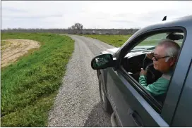  ?? ?? Acting general manager of Reclamatio­n District 2140Jose Puente, of Hamilton City, drives slowly while inspecting the condition of the levee in Hamilton City on Friday.