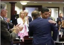  ?? SCOTT KEELER — TAMPA BAY TIMES VIA AP ?? Rep. Jose Oliva, R- Miami Lakes, is hugged and congratula­ted by House members as the gun and school safety bill passed the Florida House 67-50 in Tallahasse­e, Fla., Wednesday. Oliva shepherd the bill through the House.