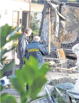  ?? PHOTO: COLLINS PHOTOS ?? Aftermath: Garda forensic teams examine the scene of the fatal blaze