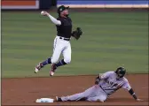  ?? MARTA LAVANDIER — THE ASSOCIATED PRESS ?? Marlins second baseman Jazz Chisholm Jr. throws to first base for the double play as the Giants’ Wilmer Flores slides into second on Friday in Miami.