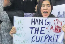  ?? HT FILE ?? A woman holding a placard during a protest against the Kathua rape and murder incident, in Srinagar.