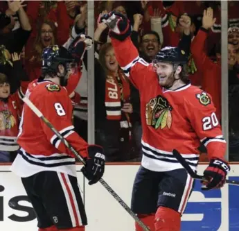  ?? NAM Y. HUH/THE ASSOCIATED PRESS ?? Blackhawks’ Brandon Saad, right, celebrates with Nick Leddy after scoring Sunday against the Wild in Chicago.