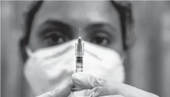  ?? ANUPAM NATH/AP ?? A health worker checks a syringe before performing a trial run of COVID-19 vaccine delivery as India prepares to kick off a coronaviru­s vaccinatio­n drive Saturday in Gauhati, India.