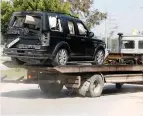  ?? (Mohammed Salem/Reuters) ?? A DAMAGED vehicle from PA Prime Minister Rami Hamdallah’s convoy is removed following an assassinat­ion attempt in the northern Gaza Strip yesterday.