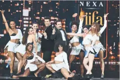  ?? — AFP photos ?? (Far right) Alia Bhatt performs during the IIFA Awards of the 18th Internatio­nal Indian Film Academy (IIFA) Festival at the MetLife Stadium in East Rutherford, New Jersey, on July 15. • (Above) Saif Ali Khan (right) and director/producer Karan Johar...