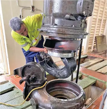  ??  ?? A Water Authority of Fiji worker finds a tyre lodged in a pump at one of their Raw Water Pumping Stations.