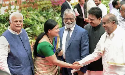  ?? PTI ?? Newly ministers, including Jayamala, greet each other during the swearing-in ceremony at Raj Bhavan in Bengaluru on Wednesday. —