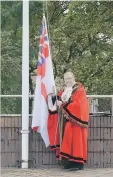  ??  ?? Coun Alan Emerson raising the flag.