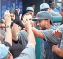  ?? CHRIS SZAGOLA/AP ?? Rey Fuentes celebrates his home run with teammates during the 10th inning of Sunday’s game against the Phillies.