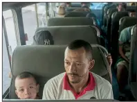  ?? AP/OLIVER DE ROS ?? Honduran migrants sit on a police bus Sunday as they wait to leave Tecun Uman, Guatemala, and return voluntaril­y to their country. The migrants had grown tired of walking and accepted a government offer to bus them to the Honduran border.