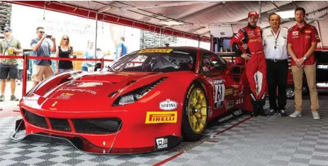  ?? R. FERRI MOTORSPORT ?? Alex Riberas, left, Remo Ferri and Kyle Marcelli next to a Ferrari race car. The car’s steering wheel has 20 buttons and there are another 20 on the dash.