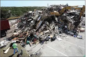  ?? (The Virginian-Pilot/Steve Earley) ?? A mountain of 11,000 cubic yards of constructi­on debris is piled in a parking lot as Ocracoke, N.C., recovers from Hurricane Dorian flooding in September, 2019.