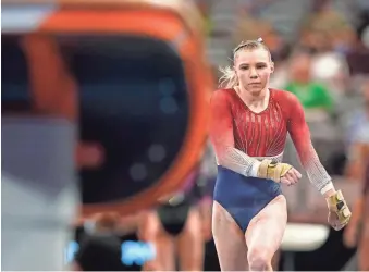  ?? TONY GUTIERREZ/AP ?? Jade Carey takes a practice run at the vault during warmups before the U.S. Gymnastics Championsh­ips on June 6 in Fort Worth, Texas.