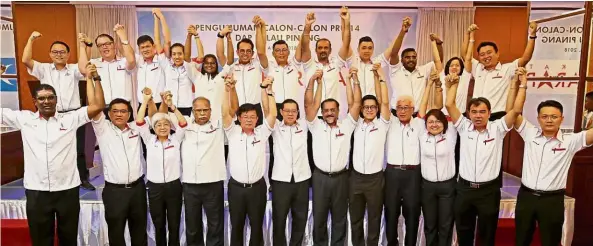  ??  ?? We’re ready: The candidates for GE14 raising their hands in union after the announceme­nt ceremony at the Evergreen Laurel Hotel in George Town.