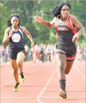  ?? Peter Hvizdak / Hearst Connecticu­t Media ?? Cromwell’s Andraya Yearwood, right, wins a girls 100-meter dash qualifying run for the finals during the CIAC Class M outdoor track and field championsh­ips May 29.