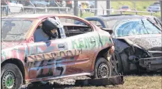  ?? CAROLE MORRIS-UNDERHILL ?? Michael Rhynold lines up his vehicle to smash into Lee Hart’s Pontiac G5 during demolition derby action Sept. 15.