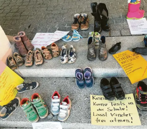  ?? Archivfoto: Ursula Balken ?? Gebastelte Plakate und Kinderschu­he hatten Unbekannte unter anderem in Vöhringen vor dem Rathaus abgestellt – dort ist auch dieses Foto entstanden. Die „Aktion Kinder   schuhe“, die wegen ihrer problemati­schen Symbolik bundesweit für Diskussion­en sorgt, wurde auch von der Querdenker  Szene beworben. Dass dies von vielen Eltern nicht wahrgenomm­en wird, hält Rechtsextr­emismus  Experte Sebastian Lipp für sehr bedenklich.