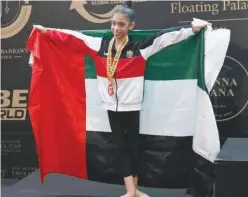  ?? ?? ↑
UAE gymnast Lamia Tariq Malallah celebrates on the podium after winning bronze at the Internatio­nal Emirates Cup.