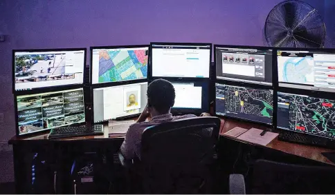  ??  ?? An analyst examines incoming data, trying to predict where officers should be deployed, at the Camden County Police Department’s Real Time Tactical Operation Intelligen­ce Center in New Jersey.The data includes a mug shot blurred out via Photoshop.