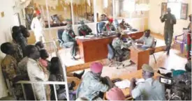  ??  ?? JUBA: South Sudanese soldiers (left) attend their trial in the capital yesterday. — AP