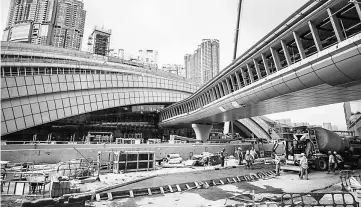  ??  ?? Labourers work on the constructi­on site of the West Kowloon terminus of the high-speed rail link which will connect the city to the southern Chinese city of Guangzhou in Hong Kong. — AFP photo