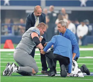  ?? ASSOCIATED PRESS ?? Detroit Lions offensive guard T.J. Lang, (left) a former Packer, suffered a concussion in Sunday’s game against the Cowboys.