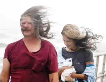  ?? Corpus Christi Caller-Times via The Associated Press ?? ■ People’s hair blows in the wind ahead of Tropical Storm Nicholas on Monday on the North Packery Channel Jetty in Corpus Christi, Texas. Winds are expected to be as high as 60 mph there, according to the National Weather Service.