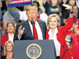  ?? AP PHOTO ?? Republican interim senator Cindy Hyde-Smith and President Donald Trump wave during a rally last month in Biloxi, Miss.