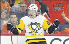  ?? TOM MIHALEK — THE ASSOCIATED PRESS ?? Pittsburgh’s Jake Guentzel celebrates one of the three goals he scored during the third period of Game 6 against Philadelph­ia. He scored four goals Sunday.