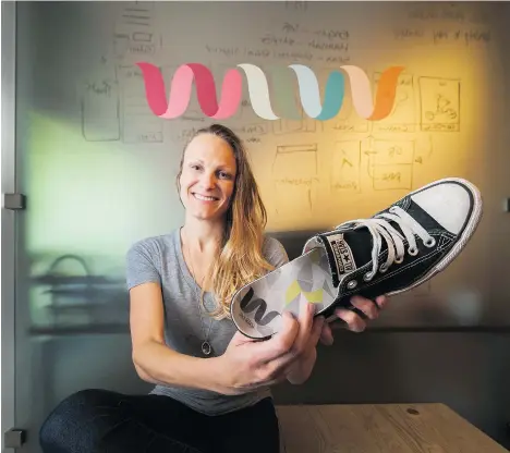  ?? ARLEN REDEKOP ?? Jen Riley shows an insole made by Wiivv Wearables in Vancouver. Wiivv is a local tech startup that custom manufactur­es shoe insoles with 3-D printing. The company used Kickstarte­r as a marketing method to bridge their way into production without having to finance inventory.
