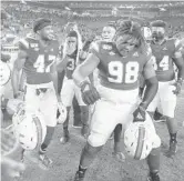  ?? MICHAEL LAUGHLIN/SUN SENTINEL ?? Miami’s Jalar Holley shows his dance moves after the Hurricanes beat Louisville last season.