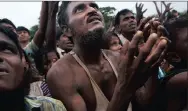  ??  ?? A Rohingya man waits for food distribute­d by volunteers in Kutupalong, Bangladesh, which has offered land to fleeing Rohingya Muslims.