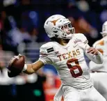  ?? Tim Warner / Getty Images ?? Junior Casey Thompson, who tossed four TD passes in Texas’ 2020 Alamo Bowl win, is dueling with freshman Hudson Card for the QB job.