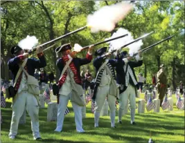  ?? AP PHOTO ?? The Sons of the American Revolution, Pikes Peak Chapter fire their guns during a historic reenactmen­t on Memorial Day at the Evergreen Cemetery on Monday.