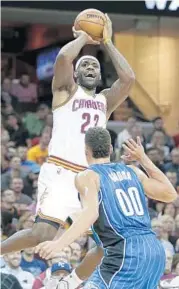  ?? TONY DEJAK/ASSOCIATED PRESS ?? The Cavs’ LeBron James (23) had 15 points, 6 rebounds and 13 assists against the Magic and Aaron Gordon.