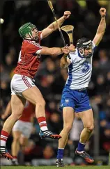  ??  ?? AIRBORNE: Waterford’s Darragh Fives (right) and Cork man William Leahy go up for a high ball during last night’s match