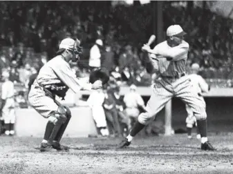  ?? Bruce Bennett / Getty Images North America ?? The New York Giants’ Fred Lindstrom bats as Muddy Ruel of the Washington Senators sets up behind home during the 1924 World Series. Ruel scored the winning run to clinch the series.