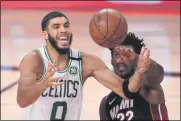  ?? MARK J. TERRILL - THE ASSOCIATED PRESS ?? Boston Celtics’ Jayson Tatum (0) and Miami Heat’s Jimmy Butler (22) battle for a rebound during the second half of an NBA conference final playoff basketball game Sunday, Sept. 27, 2020, in Lake Buena Vista, Fla.