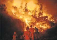  ?? Noah Berger / Associated Press ?? Firefighte­rs monitor a backfire in the Ranch Fire. Utah firefighte­r Matthew Burchett died battling the blaze.