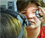  ?? BILL LACKEY PHOTOS / STAFF ?? Southeaste­rn students Eddie Jones (left) and Zachary Dennen (right) gets their eyes examined by Dr. Lindsay Florkey at Miami View School on Friday. The Ohio Optometric Associatio­n held an In-school Eye Exam (ISEE) event at Miami View School. The ISEE program is operated by the Ohio Optometric Foundation (OOF) and provides comprehens­ive eye exams to students identified by school nurses as needing vision care. The students then get to pick out and are fitted for glasses that they receive at no charge.