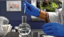  ?? KATHERINE FREY / WASHINGTON POST ?? Marie Wright, vice president and chief global flavorist at Archer Daniels Midland, creates a black truffle flavor to be used in an aioli at ADM’s lab in Cranbury, New Jersey.