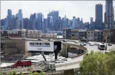  ?? AP PHOTO/MARK LENNIHAN, FILE ?? In this June 21 file photo, traffic spirals upand-down a section of Route 495 to the Lincoln Tunnel in Weehawken, N.J., with the New York City skyline in the background.