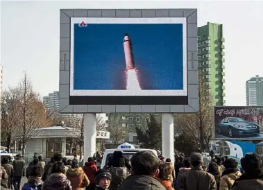  ??  ?? Blast off: People in Pyongyang watching a public broadcast of a surface-tosurface ballistic missile Pukguksong-2 launch at an undisclose­d location on Feb 12. — AFP