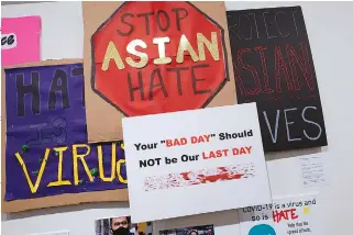  ?? ASSOCIATED PRESS PHOTO ?? Signs used during anti Asian hate protests are seen on display during the press preview of “Responses: Asian American Voices Resisting the Tides of Racism” at the Museum of Chinese in America in New York.
