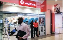  ?? PHOTO: BLOOMBERG ?? Employees at a Vodacom Group telecoms store in Johannesbu­rg. There are big bucks to be made in providing corporatio­ns with IoT infrastruc­ture, says the writer.