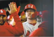  ?? Dylan Buell / Getty Images ?? St. Louis’ Miles Mikolas celebrates with teammates after his fifth-inning homer, his first big-league hit.