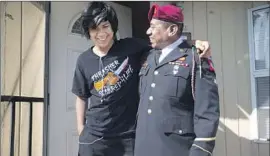  ?? Kent Nishimura Los Angeles Times ?? FABIAN REBOLLEDO embraces his son Derick in Azusa on Wednesday, the father’s first day back in the U.S. after being deported to Tijuana eight years ago.