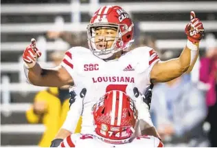  ?? ANDREW DYE AP ?? Louisiana running back Trey Ragas (top) celebrates after running for a TD against Appalachia­n State. No. 25 Louisiana held on to win 24-21 Friday when the Mountainee­rs missed a short FG try.