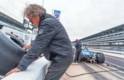  ?? ?? A Rahal Letterman Lanigan Racing crew member pulls a tire for driver Christian Lundgaard on Wednesday during open testing at Indianapol­is Motor Speedway ahead of the 108th running of the Indianapol­is 500.