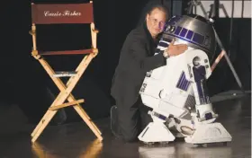  ?? Kevin Winter / Getty Images ?? Todd Fisher, with “Star Wars” robot R2-D2, speaks at a memorial for his mother, Debbie Reynolds, and sister, Carrie Fisher, at Forest Lawn cemetery.